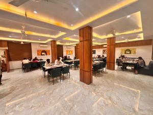a dining room with people sitting at tables at Vantara Gir Resort in Sasan Gir +19 photos