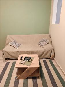 a small room with a bed and a table at Central Modern Living Apartment 1 in Eleftheroúpolis