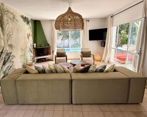 a living room with a couch and a table at Villa TerraVerde in Al Ghar