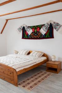 a bedroom with a wooden bed and a table at Sieben Türen in Criţ