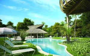 a swimming pool with lounge chairs and umbrellas at Casa Maya in Puerto Morelos