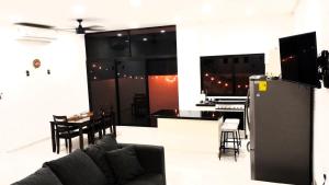 a living room and kitchen with a couch and a counter at Casa Maya in Puerto Morelos