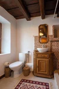a bathroom with a toilet and a sink and a mirror at Sieben Türen in Criţ +35 photos