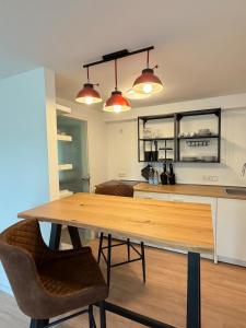 a kitchen with a wooden table and two chairs at Apartment Am Wald in Idar-Oberstein