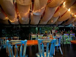 a restaurant with blue chairs and a wooden table at La Finestra Spa Hotel Boutique in La Vega