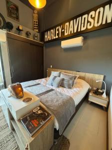 a bedroom with a harley davidson sign on the wall at Hotel Rioverde Loft cerca De Aeropuerto Jmc in Rionegro +11 photos