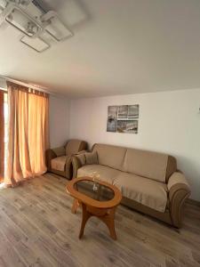 a living room with a couch and a coffee table at Deltaville in Mahmudia +13 photos