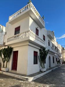 a white building with trees in front of it at Almyra Summer Homes in Ierapetra