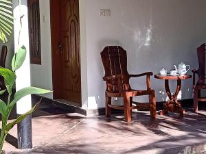 a room with a chair and a small table at Tropical Lodge Yala in Kirinda