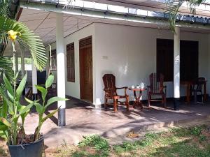 a patio with a table and chairs on a house at Tropical Lodge Yala in Kirinda