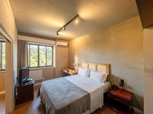 a bedroom with a bed and a television at Hotel Prinz in Joinville +126 photos