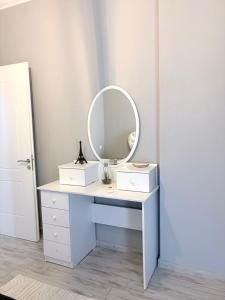 a dressing table with a mirror on top of it at Vila 007 in Velipojë +18 photos