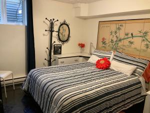 a bedroom with a bed with a black and white comforter at B&B Aux Deux Pignons in Donnacona +32 photos