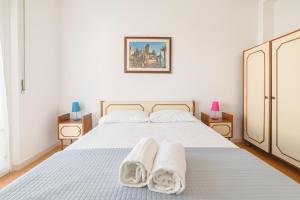a bedroom with a bed with two towels on it at Bambinopoli Al Mare in Alba Adriatica