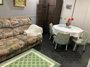 a living room with a table and a couch at B&B Aux Deux Pignons in Donnacona