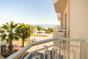 a balcony of a building with a view of the beach at Bambinopoli Al Mare in Alba Adriatica