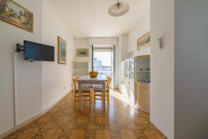 a kitchen with a table and chairs in a room at Bambinopoli Al Mare in Alba Adriatica
