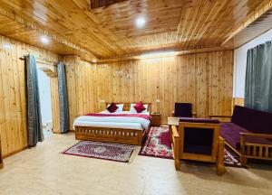 a bedroom with a bed in a wooden room at Harshil View Home Stay in Harsil