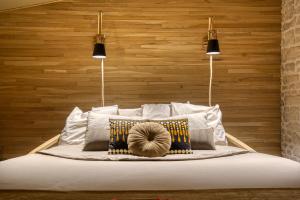 a bed with a wooden head board with two lights at SUITE TESORO climatisée avec piscine spa hammam et jardin avec piscine in Saint-Martial-sur-Né +12 photos