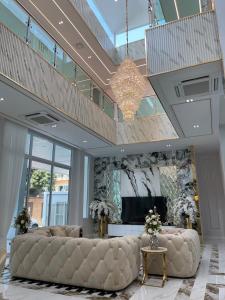 a large living room with a large couch and a chandelier at IP on HOME 1 in Jomtien Beach