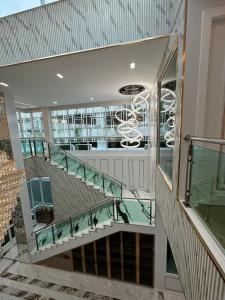 a staircase with glass railings in a building at IP on HOME 1 in Jomtien Beach