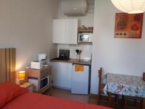 a small kitchen with a bed and a small table at Appartement Sauges 16 in Cazaubon