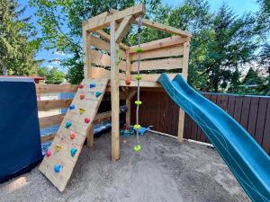 a playground with a slide and a climbing frame at Chata Björk in Babice