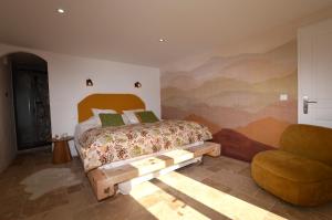 a bedroom with a bed and a chair at Villa rundinella in Vero +4 photos