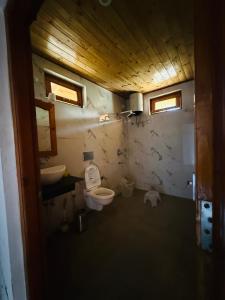 a bathroom with a toilet and a sink at Harshil View Home Stay in Harsil
