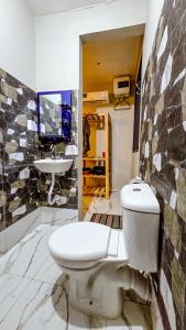 a bathroom with a toilet and a sink at 7G Residency Bwejuu in Bwejuu