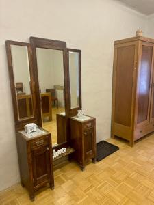 a room with two tables and two mirrors at Zámek Hošťálkovy in Hošťálkovy
