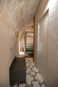 a hallway with a room with a bed and a door at Aria d'amare in Mola di Bari