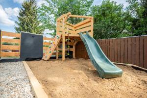 a playground with a slide in a sandbox at Chata Björk in Babice