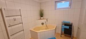 a bathroom with a sink and a window at Ferienwohnung Frate in Velden am Wörthersee +24 photos