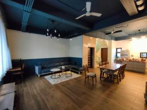 a living room with a couch and a table and chairs at 羅東夏林5號 in Luodong +15 photos