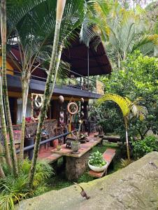 a house with a wooden table in a garden at La Finestra Spa Hotel Boutique in La Vega