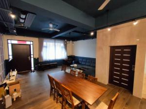 a dining room with a large wooden table and chairs at 羅東夏林5號 in Luodong