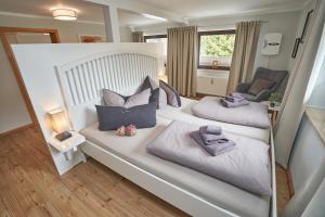 a large white bed with two pillows on it at Ferienwohnung Arnold in Stolpen