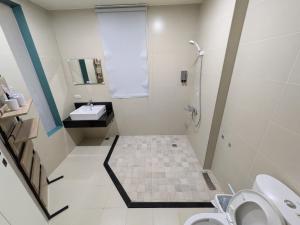 a bathroom with a shower and a sink and a toilet at 羅東夏林5號 in Luodong