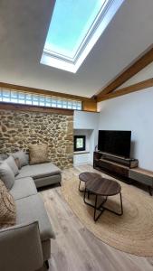 a living room with a couch and a flat screen tv at Casona de Queveda in Queveda