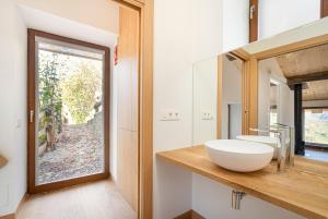 a bathroom with a white sink and a window at Benaki 99 in Ladines +22 photos