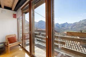 a room with a window and a view of mountains at Benaki 99 in Ladines