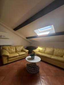 a living room with two couches and a table at Casa Sopra in Castel di Sangro