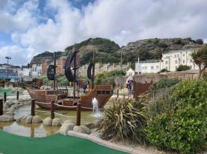 a water park with a boat in the water at Central location Sea view in Hastings