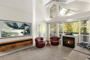 a living room with a couch and a fireplace at Glacier Lodge in Whistler