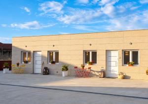 a building with doors and chairs in front of it at Malladoura Passive House in Porriño