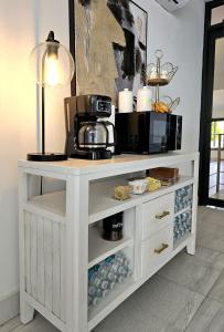 a white cabinet with a microwave on top of it at Casa de Playa Hatillo in Hatillo
