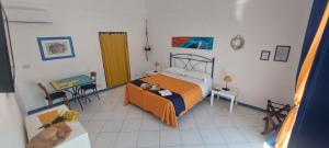 a bedroom with a bed and a table and a table sidx sidx sidx at Villa Flavia - Adults Only in Ponza