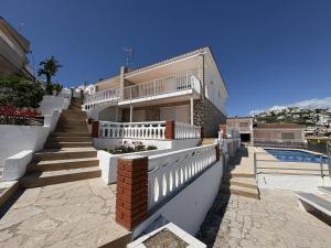 a large house with stairs and a swimming pool at Alpen1 Finca Simo in Peniscola