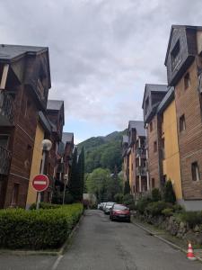 a street with buildings and cars parked on the street at Cauterets Mountain Nest in Cauterets